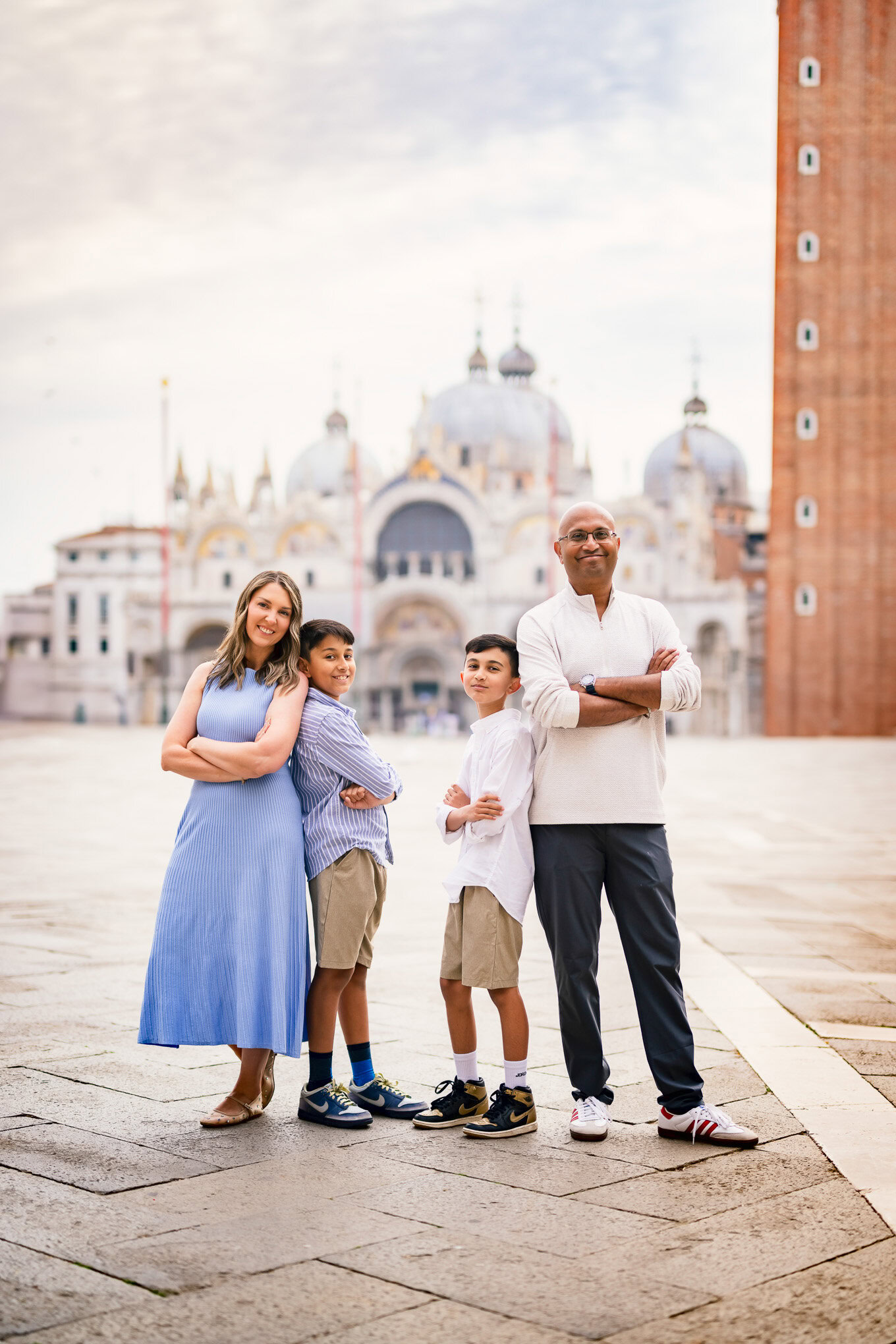 A family enjoying a sunny day in Venice, walking together near historic buildings with soft natural light illuminating t.