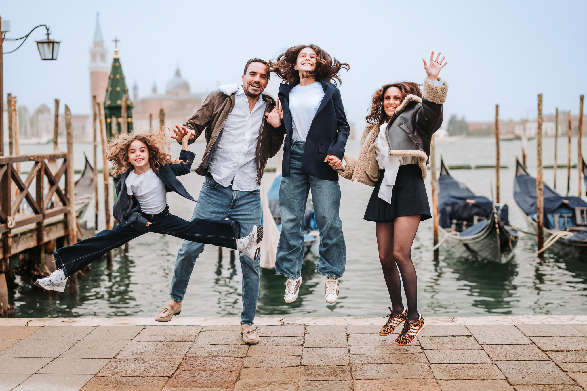 Enjoying a joyful family moment by the Venice canal with lively interaction and natural light.
