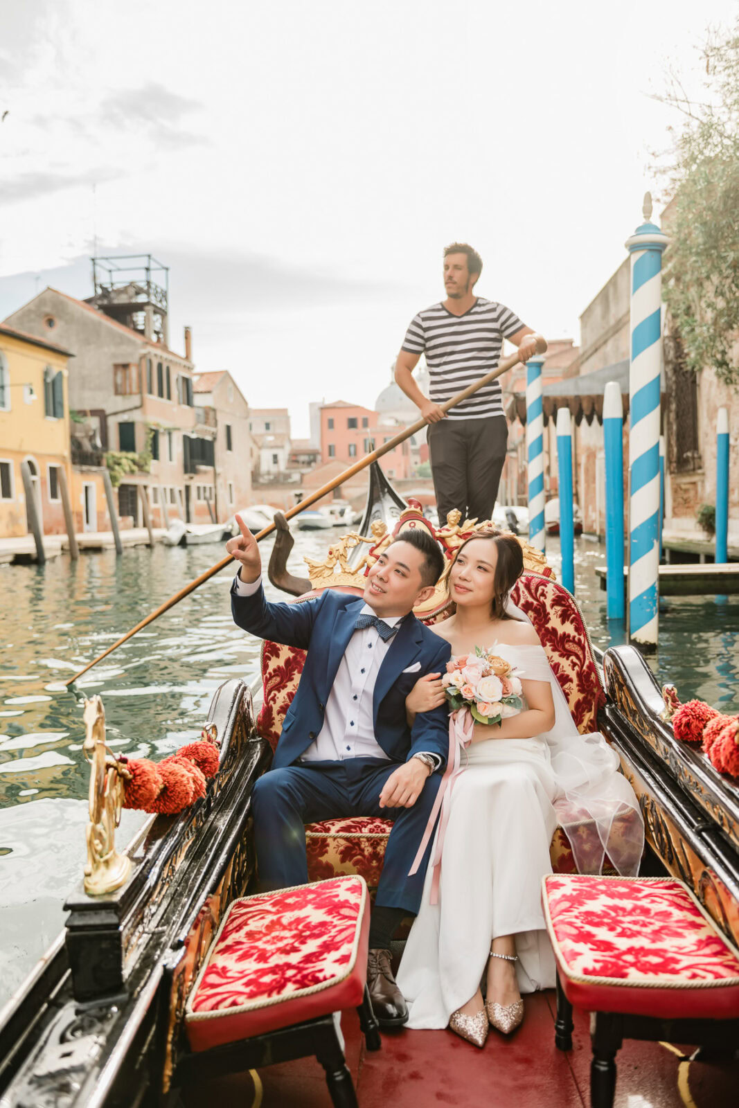 Couple enjoying a romantic gondola ride in Venice with soft light and historic scenery.