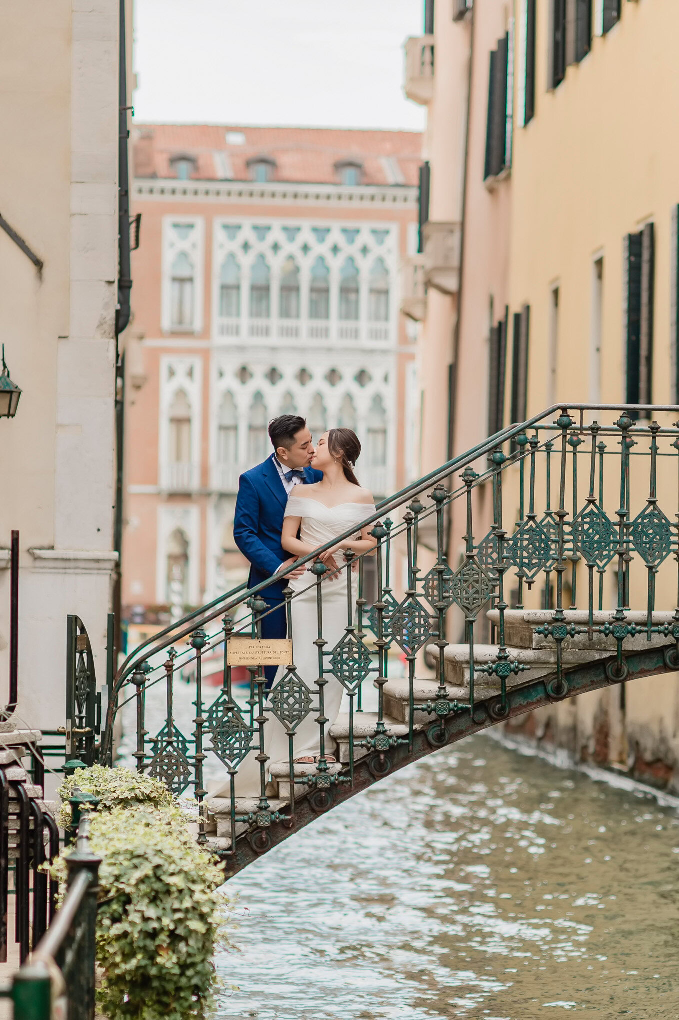 A couple sharing an intimate moment on a romantic bridge in Venice, bathed in soft natural light, exuding love and seren.