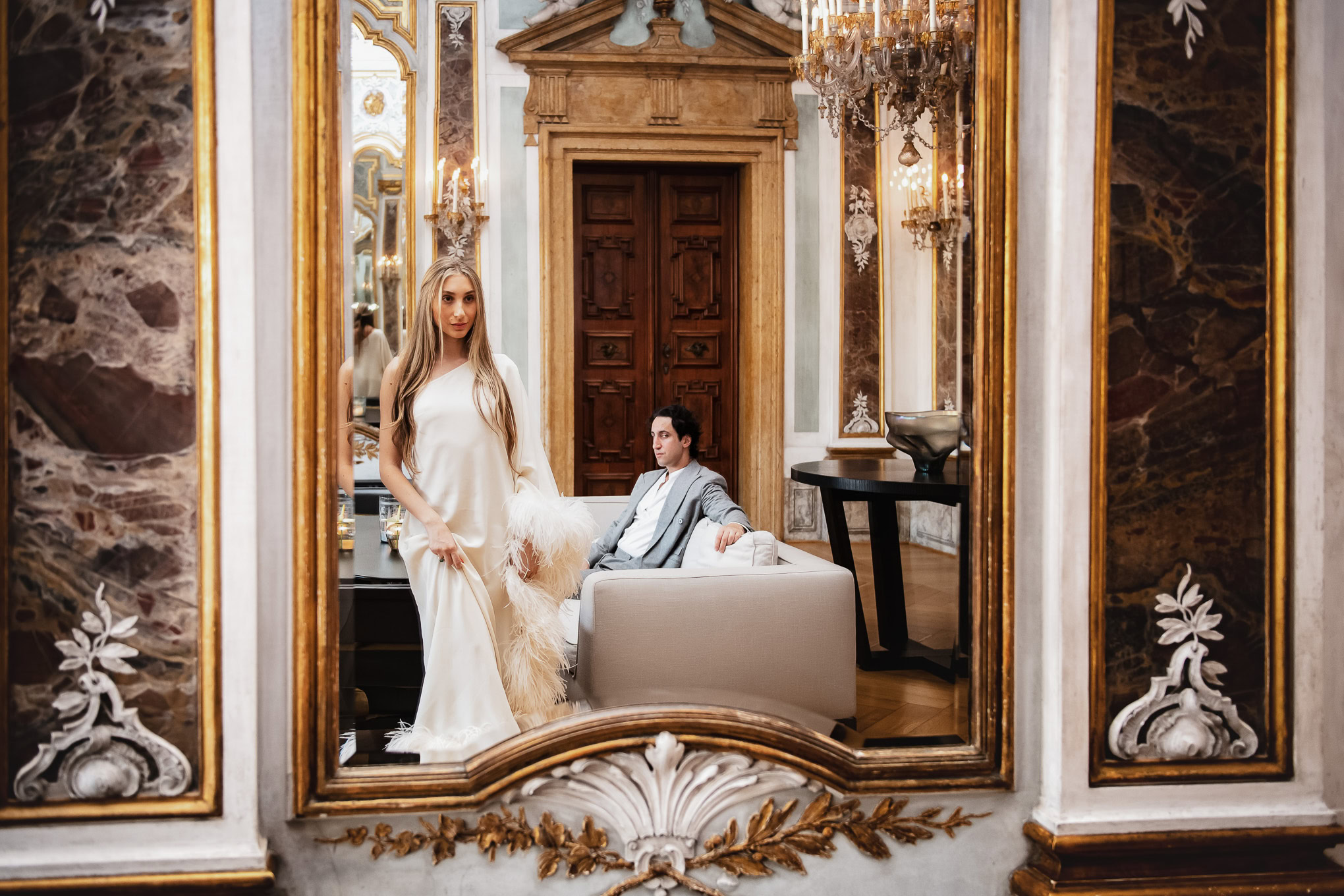 A couple enjoying a romantic moment in an opulent Venetian interior with luxurious decor and warm lighting.