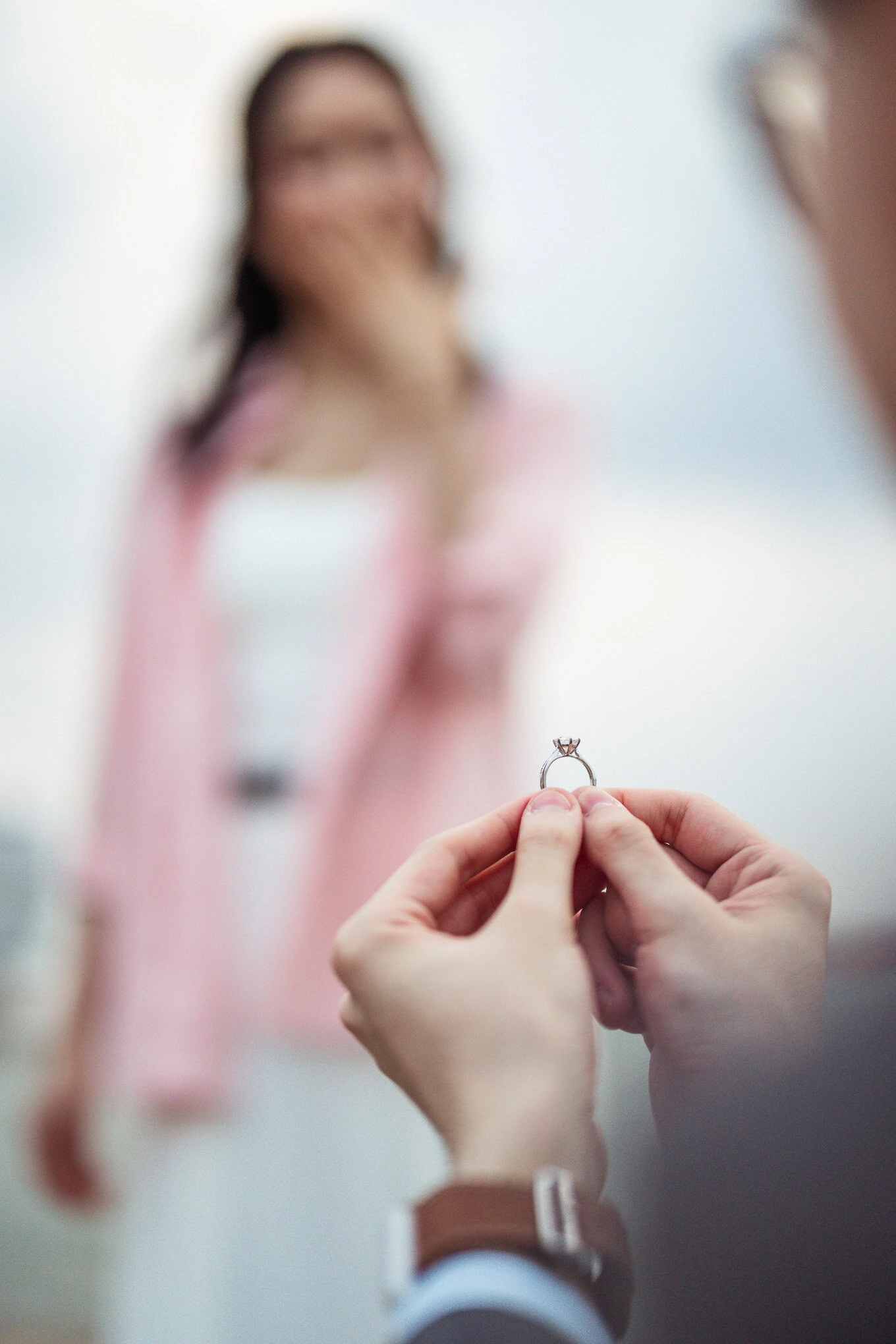 A person proposes marriage with a ring in Venice, capturing a heartfelt moment of love and surprise against the scenic b.