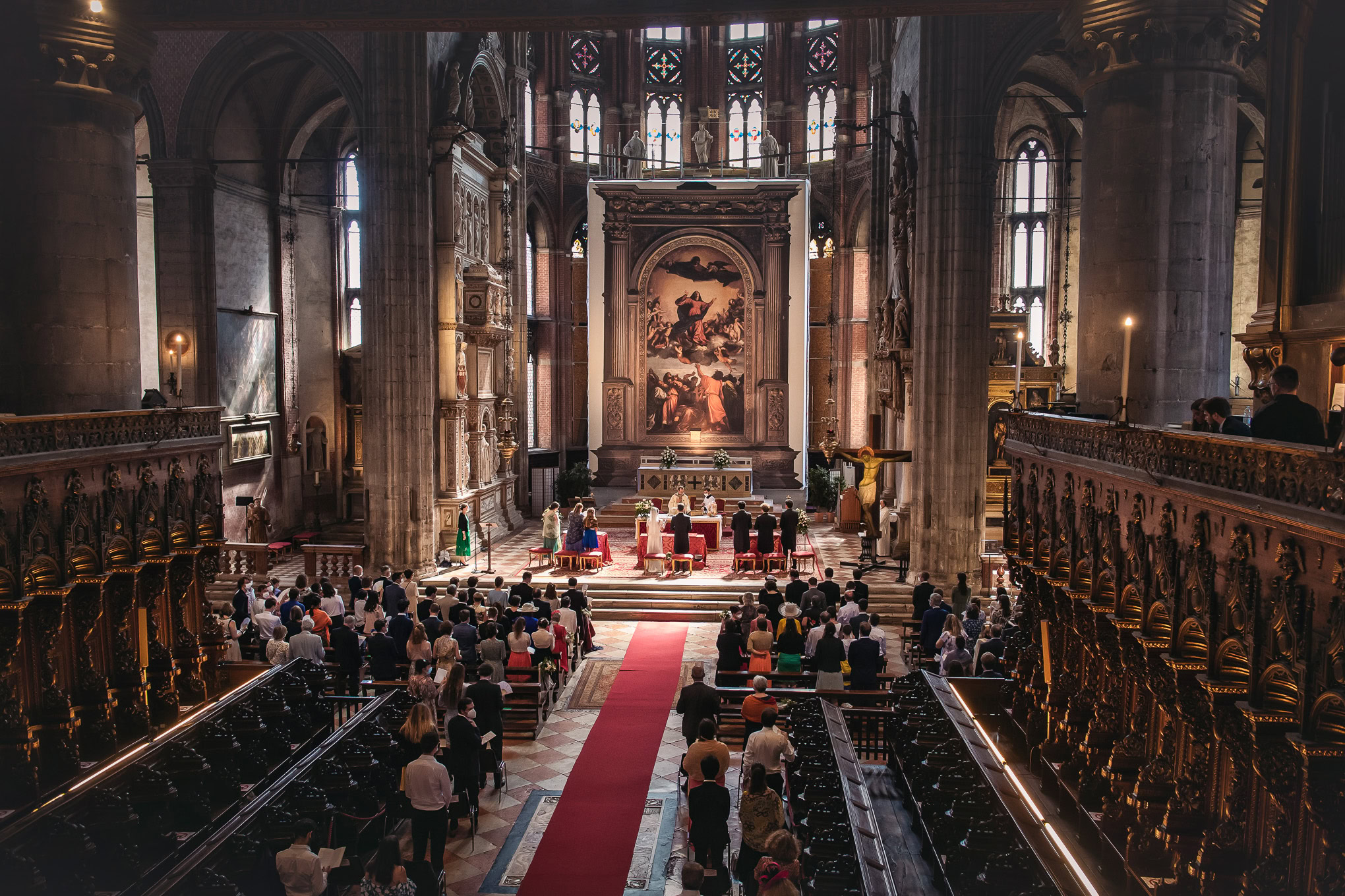 A woman or scene in a Venetian church interior with ornate architecture and a congregation attending a service or event.