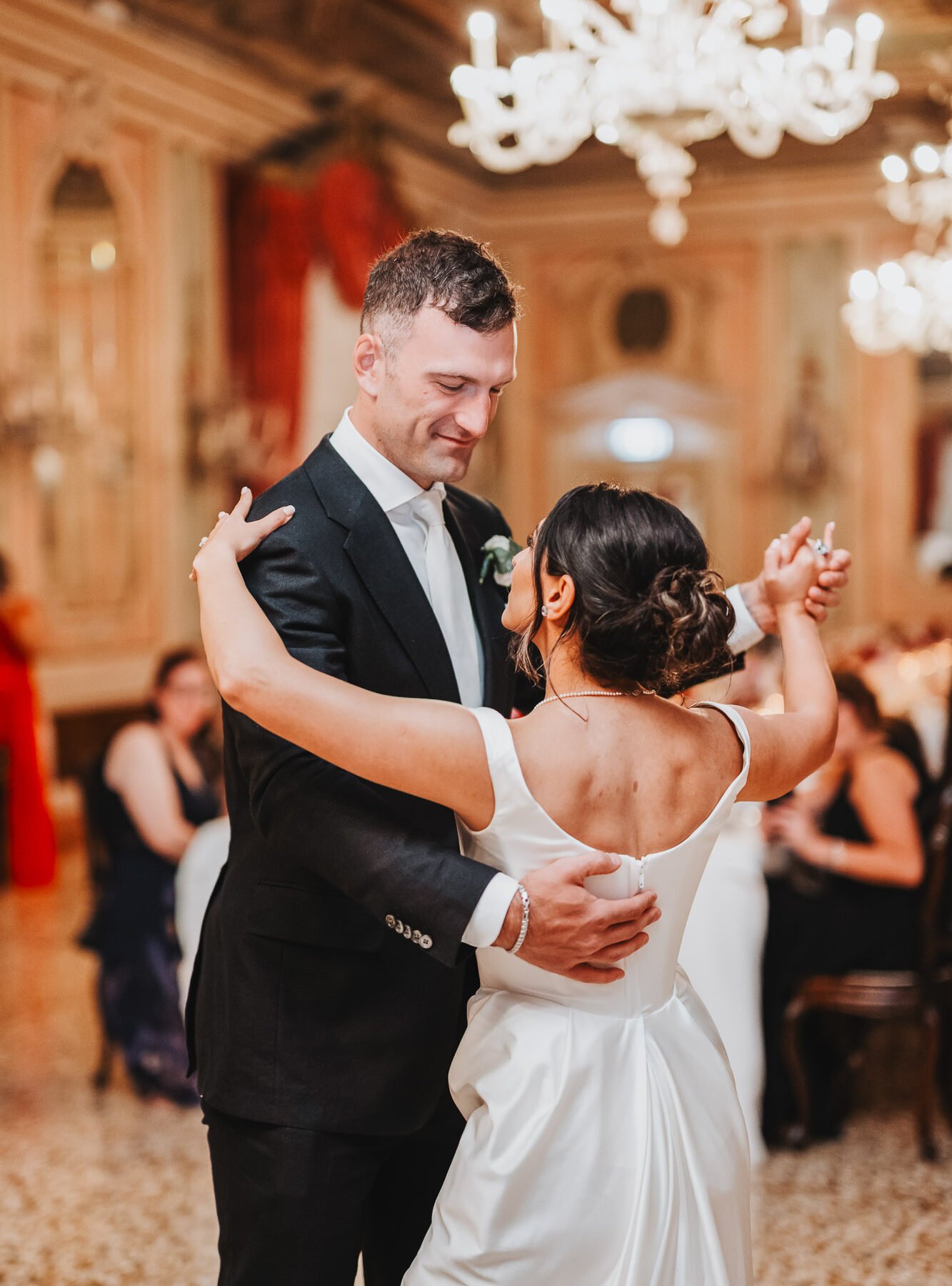 Couple dancing Baglioni Hotel Luna Venice ballroom wedding reception chandelier warm light