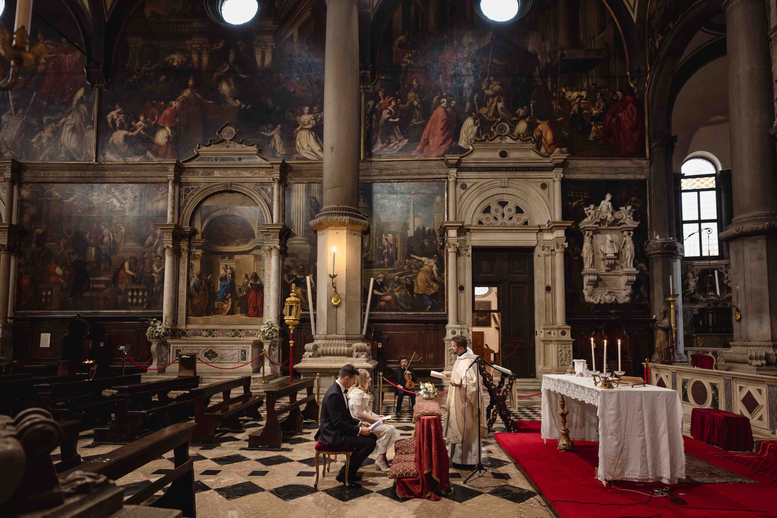 Ancient Venetian church interior with ornate architecture and religious artwork for an elopement ceremony.