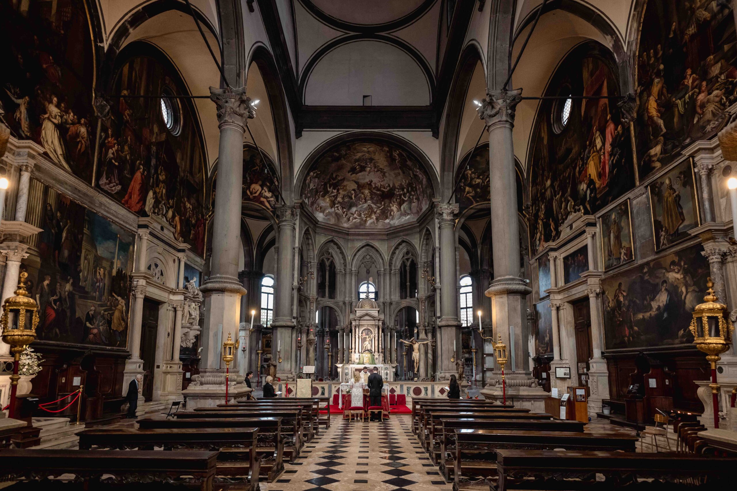 Venice church interior with ornate paintings and high vaulted ceilings for elopement in a Venetian Church.
