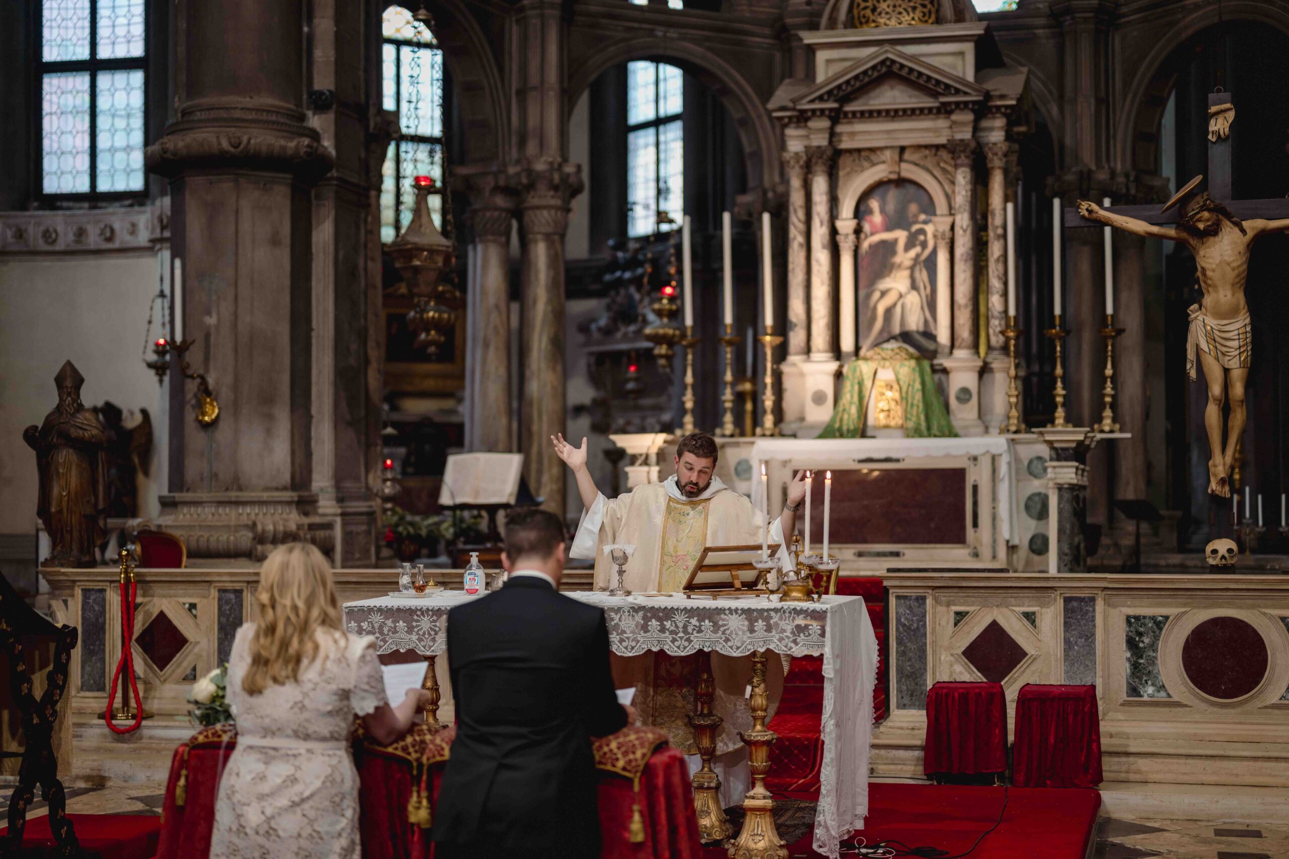 Venetian Church wedding ceremony during an elopement in Venice, Italy, with priest and couple at the altar.