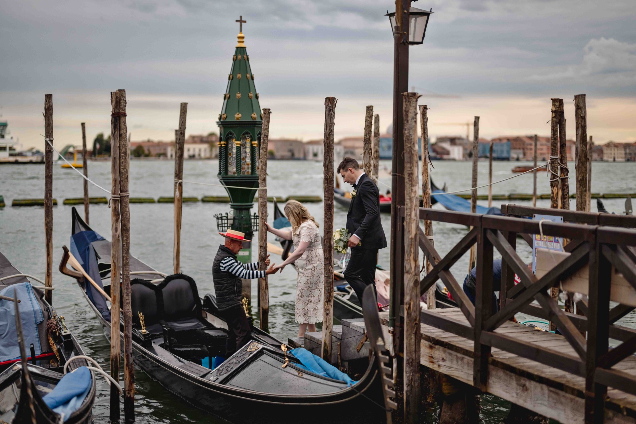 Venice, gondola dock with couple and gondolier during elopement in a Venetian church.