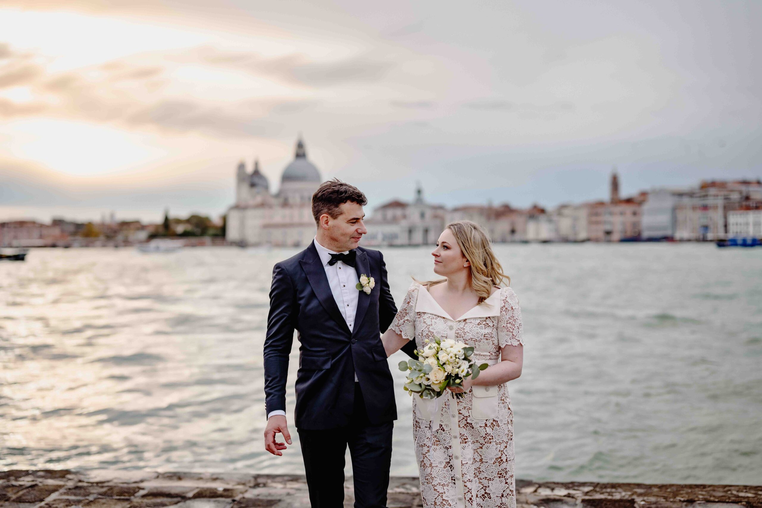 Venice, Venetian Church wedding ceremony with bride and groom by the canal at sunset.