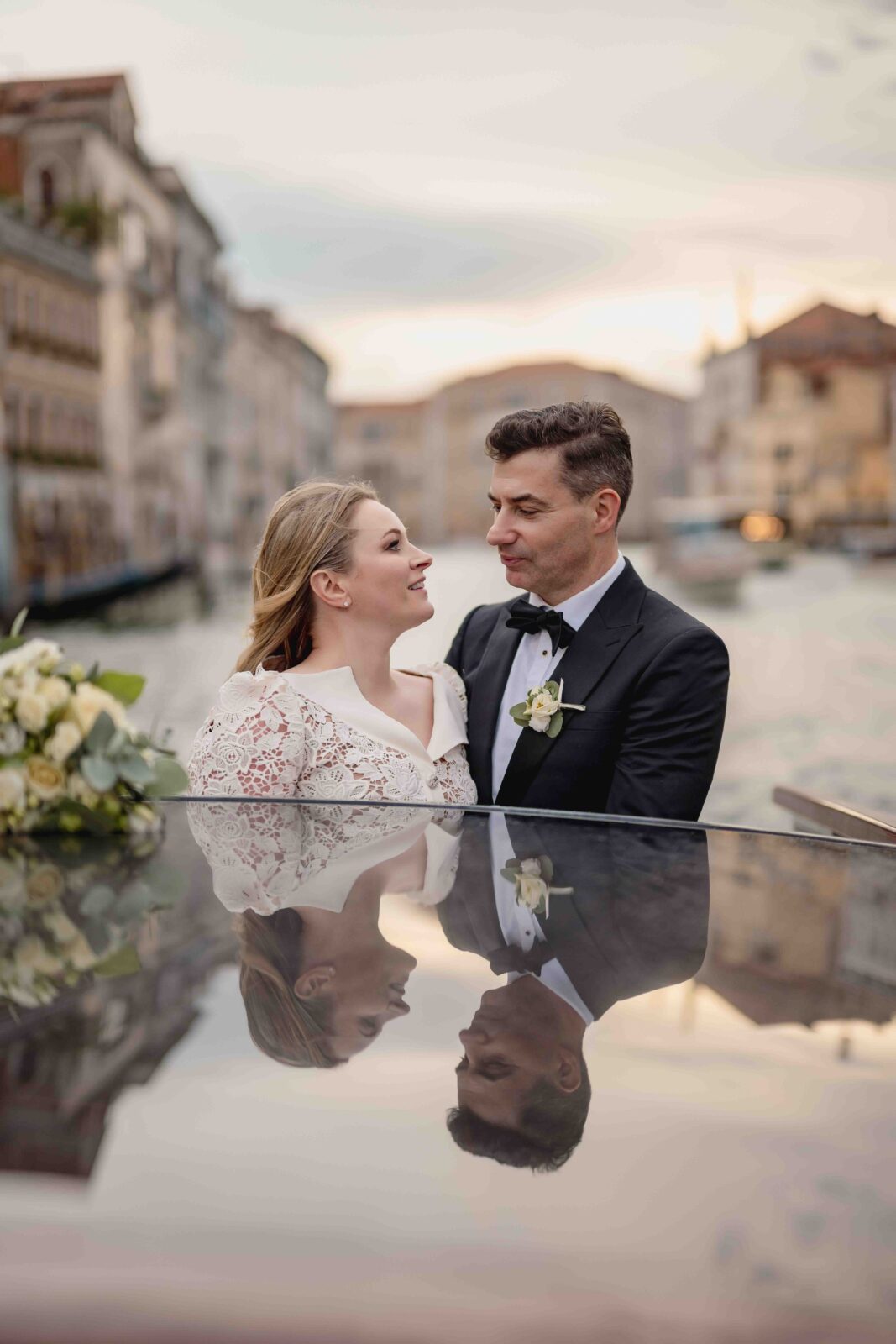 Venice, romantic couple during a wedding photo shoot on a gondola in Venice, Italy.