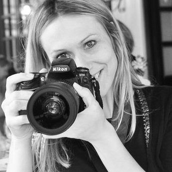 Laure Jacquemin holding a Nikon camera in Venice