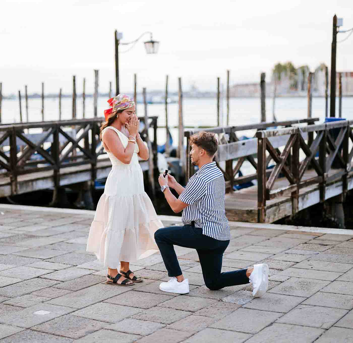 Romantic couple in Venice Italy, man proposing to woman by the canal, scenic waterfront background, Venice photography,.