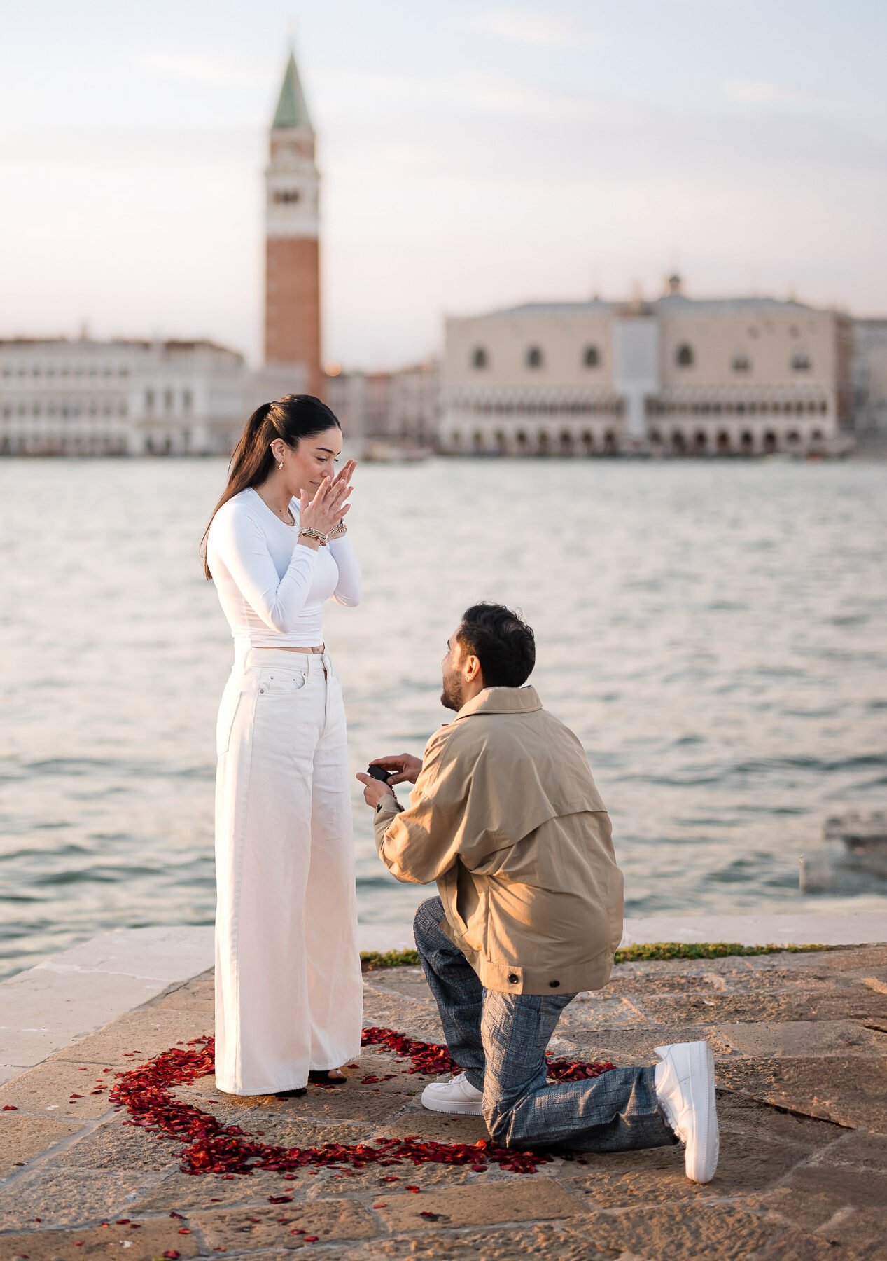 Romantic proposal at San Marco, Venice with iconic cityscape in the background.