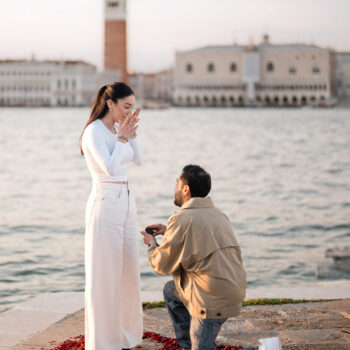 Romantic proposal at San Marco, Venice with iconic cityscape in the background.
