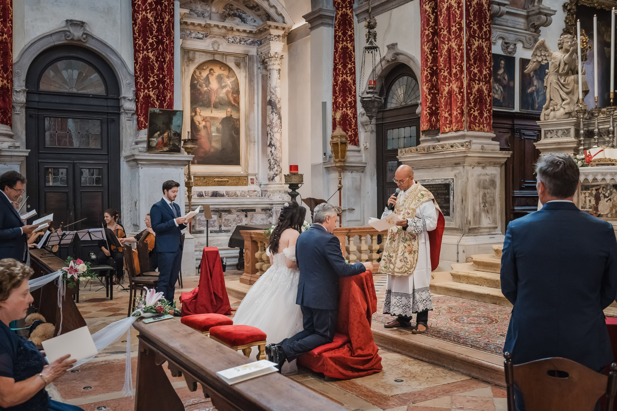 Venice church Catholic wedding ceremony with priest and bride and groom exchanging vows.