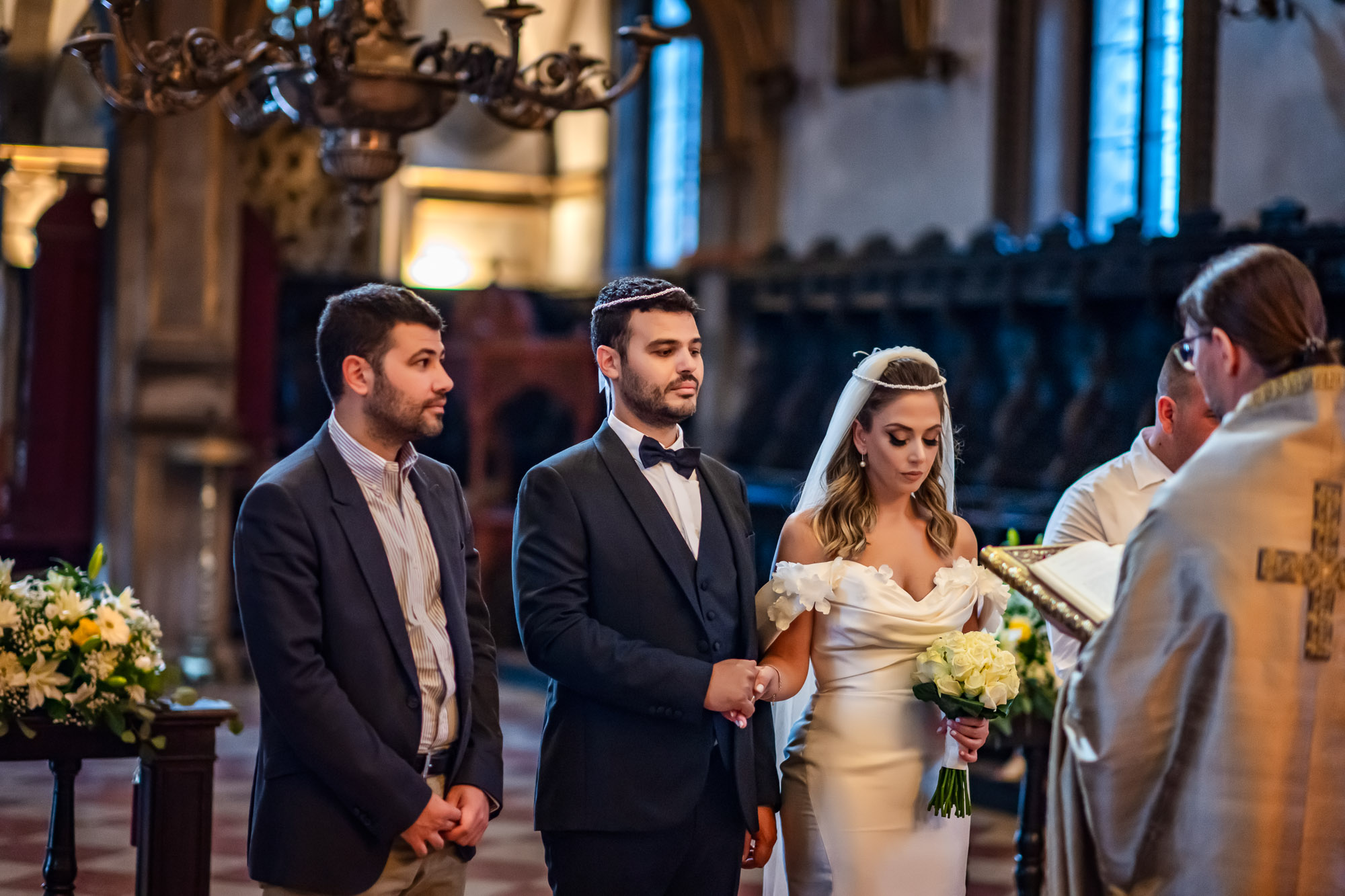 Venice church during a wedding ceremony with the bride and groom holding hands.
