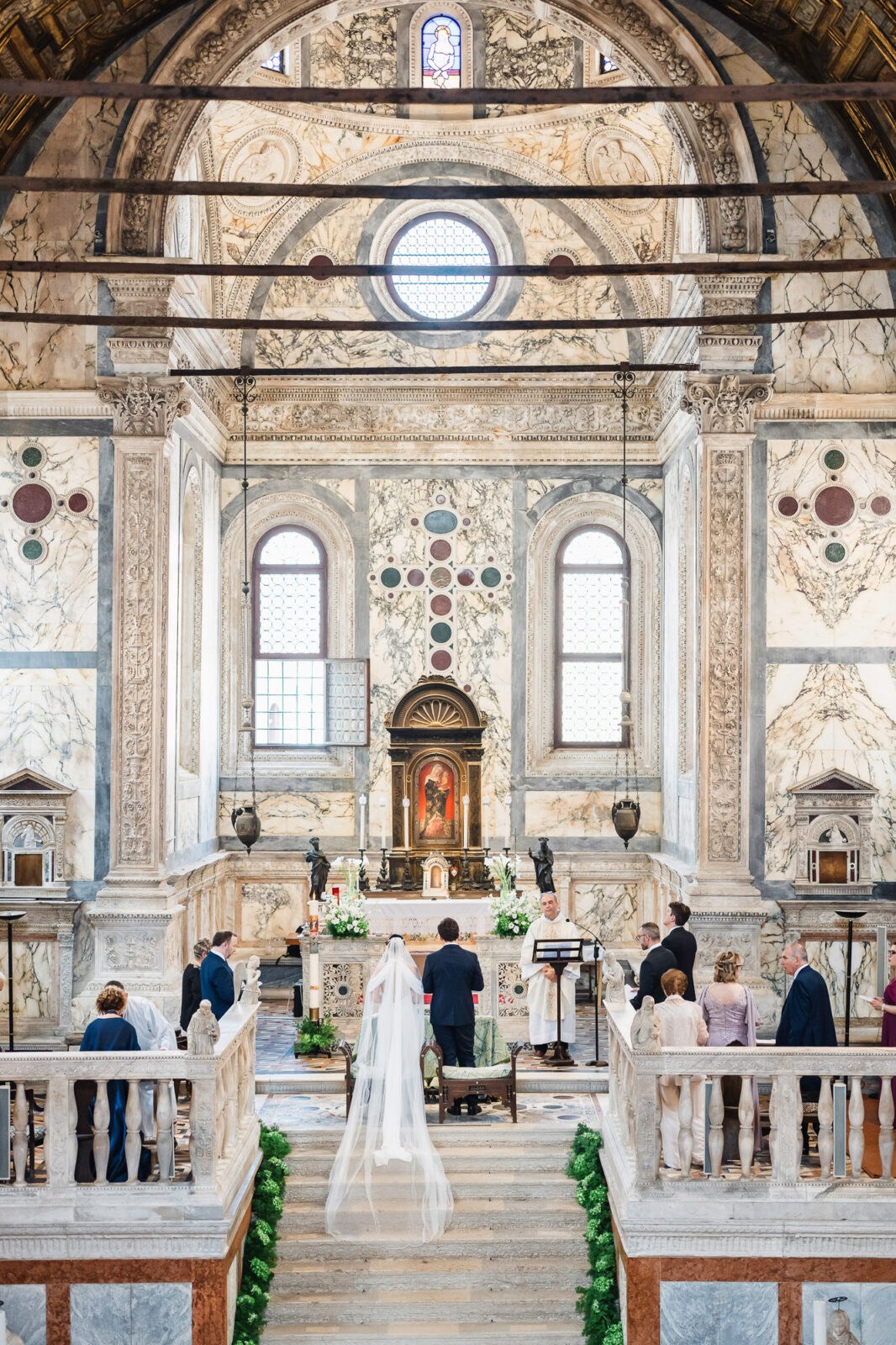 Venice church with ornate Baroque interior during a wedding ceremony.