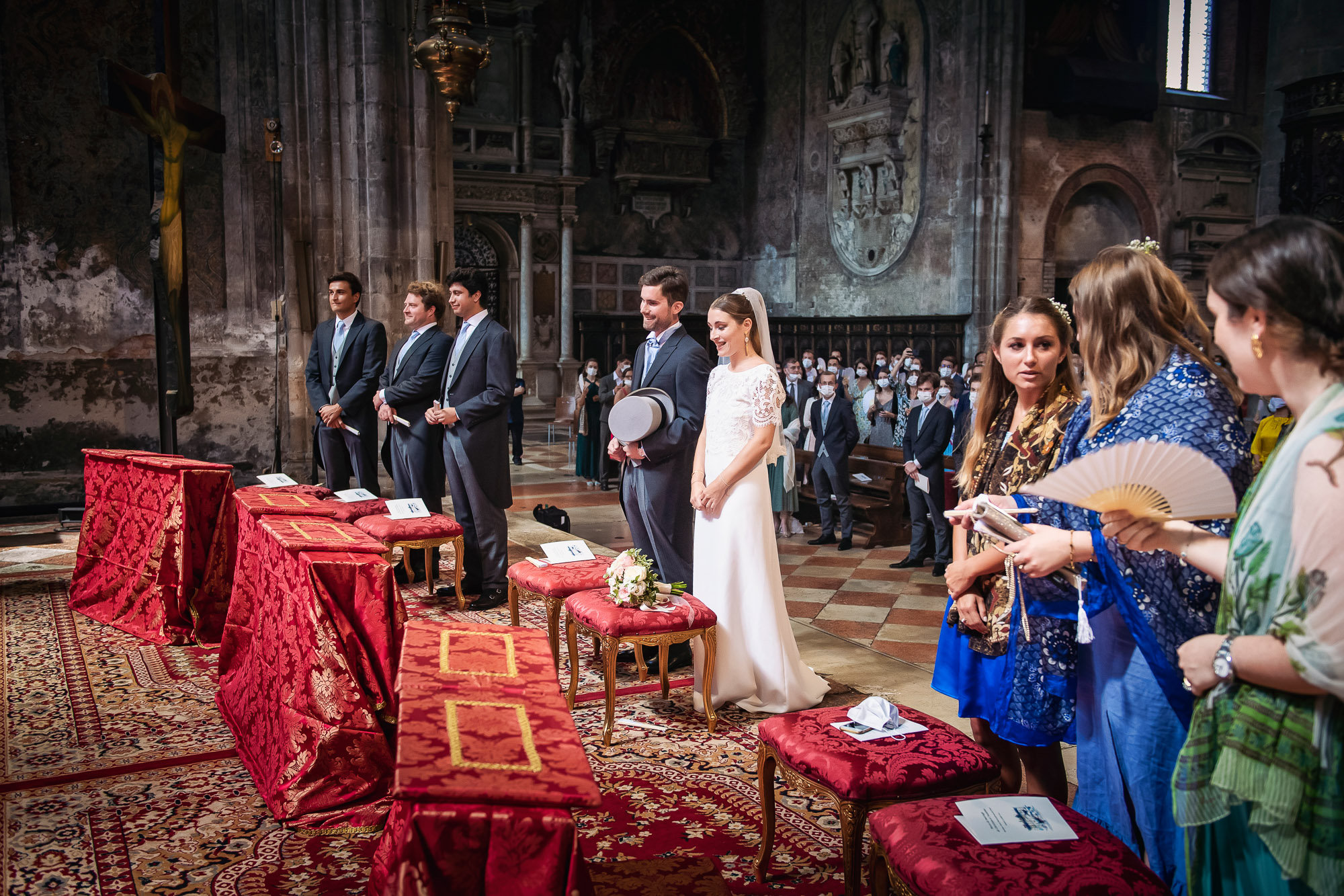 Venice church wedding ceremony with bride, groom, and guests during a religious service.