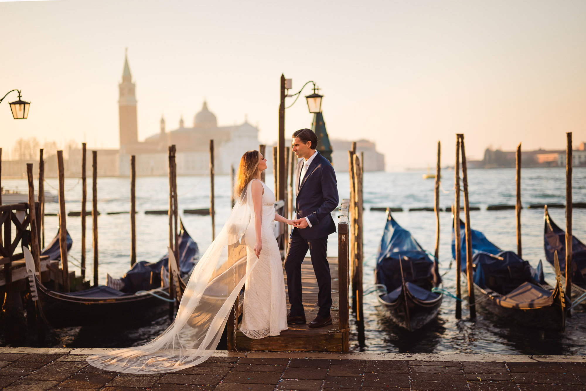 honeymoon couple portrait on Venetian pier with gondolas
