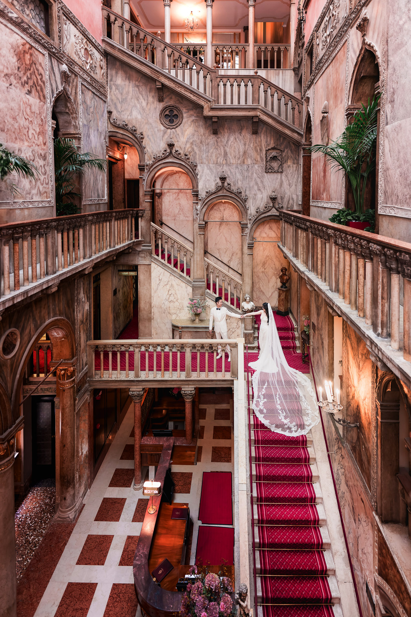 honeymoon couple kissing on the grand staircase of Hotel Danieli in Venice