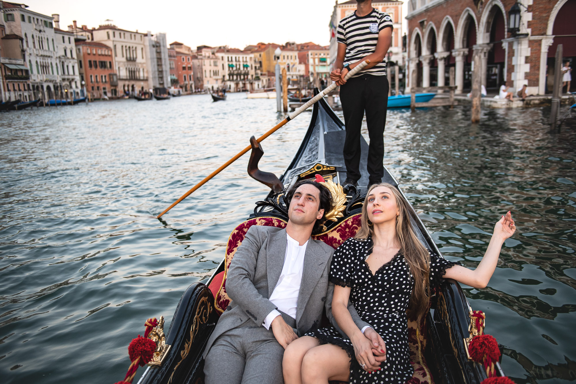 honeymoon couple relaxing in gondola on Venetian canal
