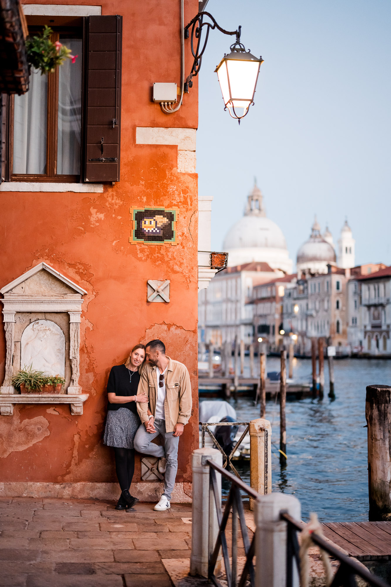 romantic honeymoon couple portrait against colorful Venetian wall