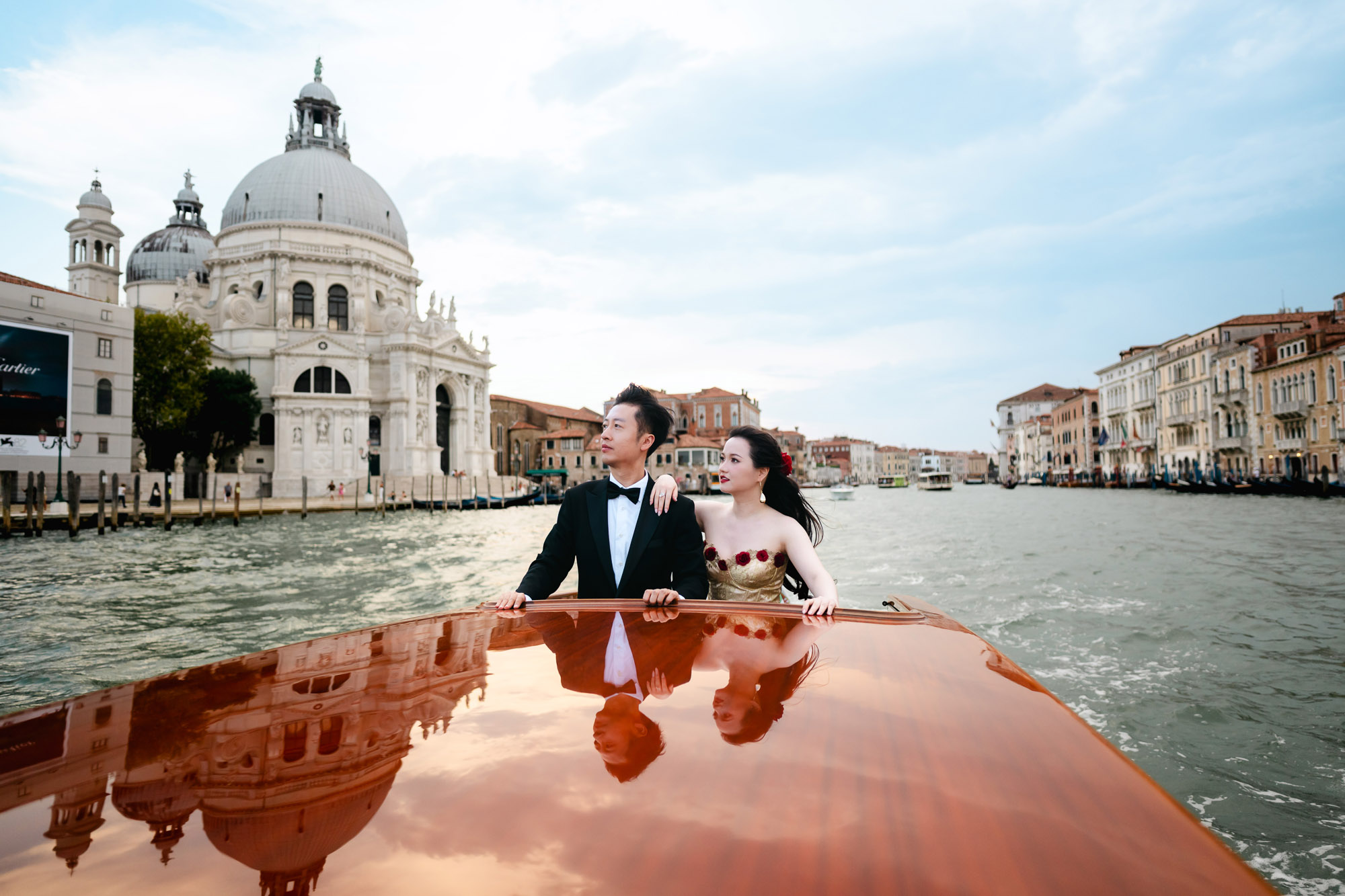 honeymoon couple portrait on vintage red boat Venice