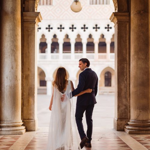 Venice-honeymoon-photographe (212) Venice wedding couple walking through historic archway in Venice, Italy.