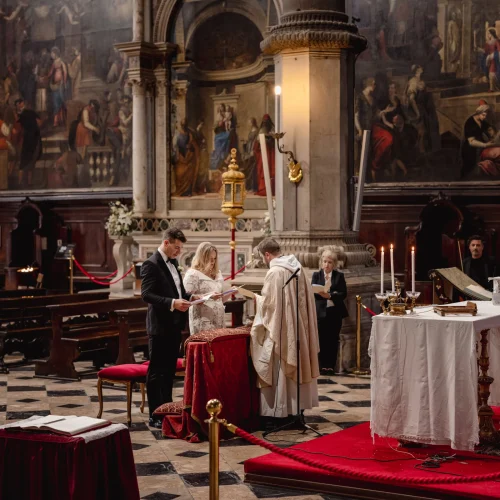 intimate-elopement-story-at-san-zaccaria-venice (24) Elegant couple exchanging vows in a historic church during an elopement ceremony.